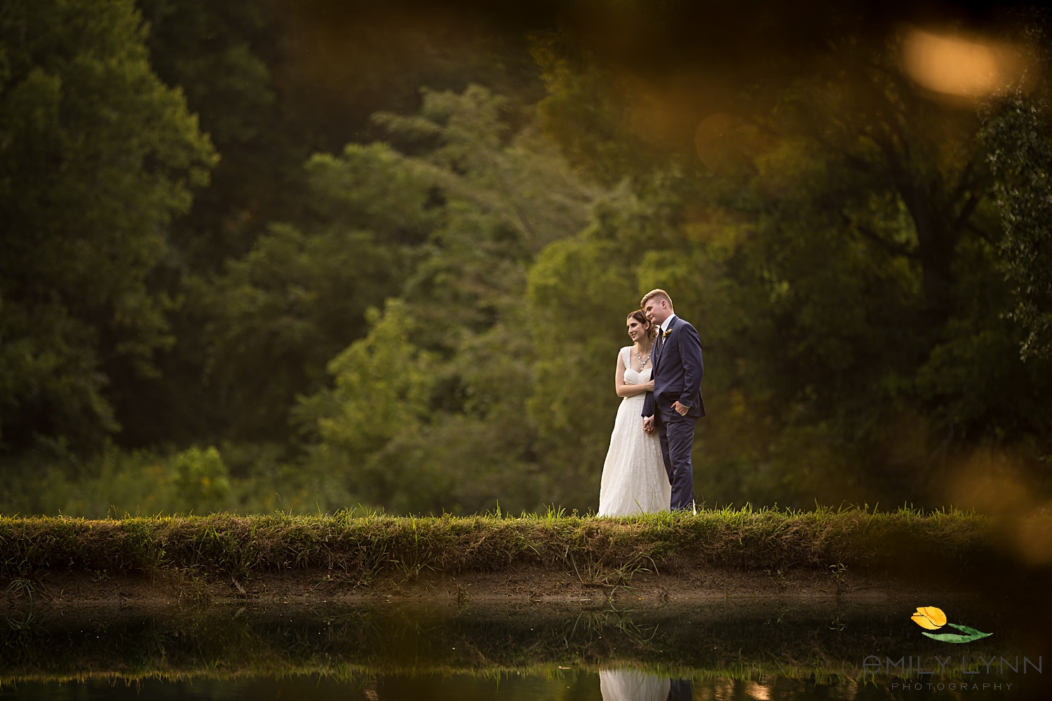 Couple's photo by the pond. Wedding-Photos-at-Enchanted-Acres-KC-Wedding-Photographer-Emily-Lynn-Photography.